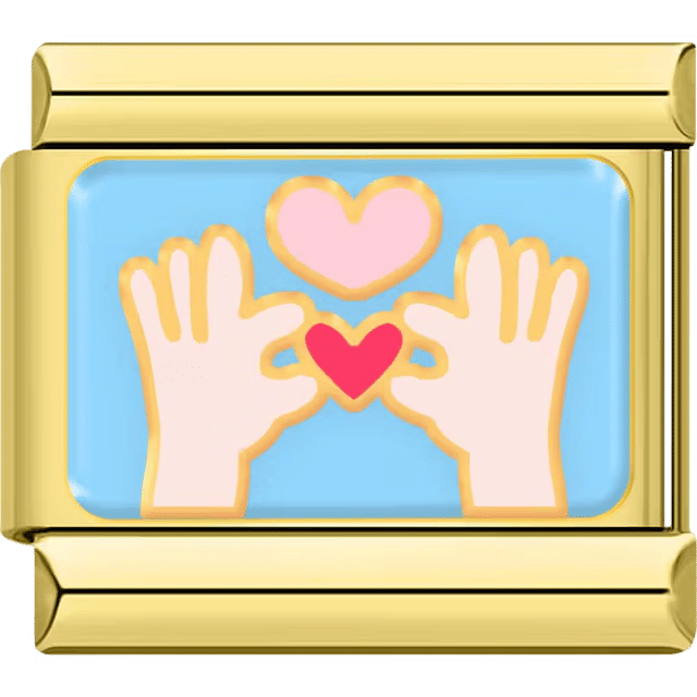 Gold Italian charm with two hands forming a heart and a floating pink heart above on a blue background.
